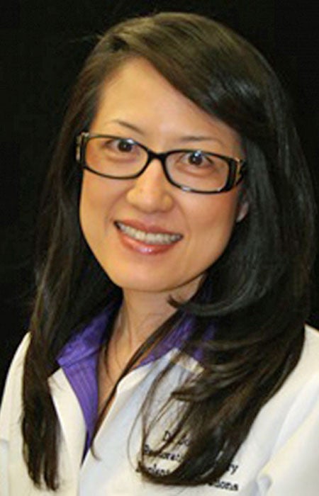 Dr. Judy Yuan in white coat