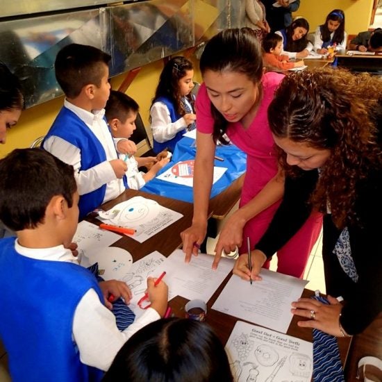 Teachers and young students in a classroom