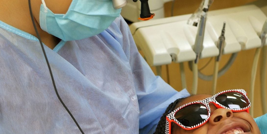 Dentist student working with a child patient