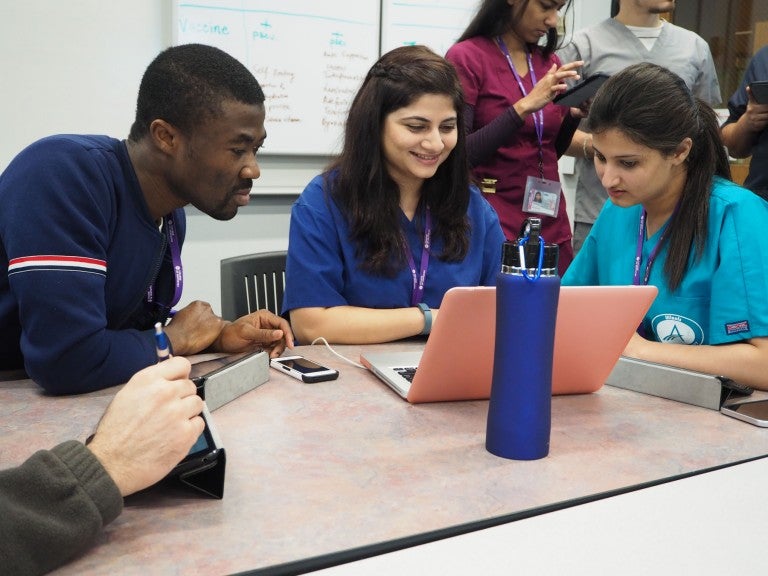 students staring at laptop