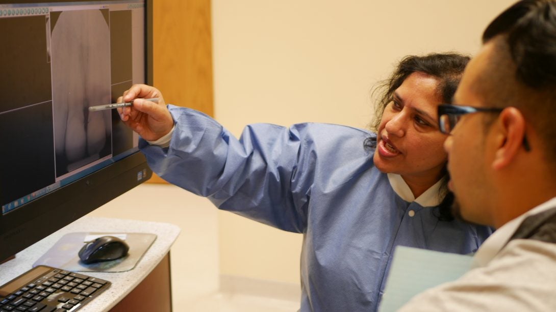 two dentists looking at computer screen