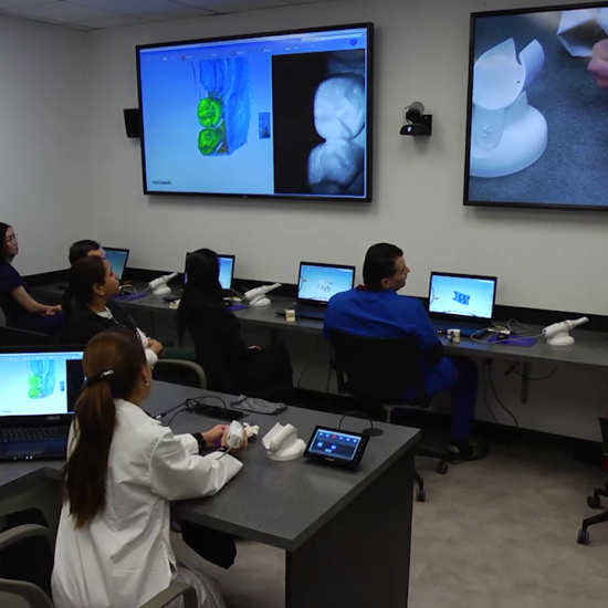 Students with computers staring at tv