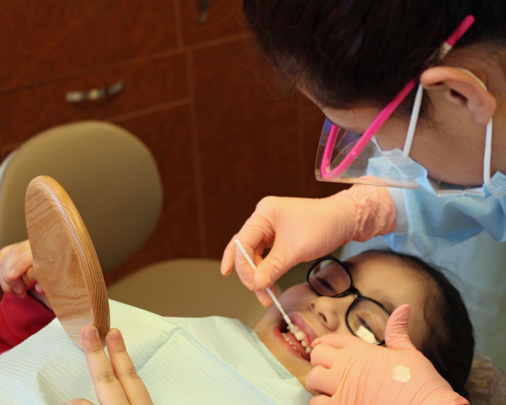 dentist working on a child's teeth