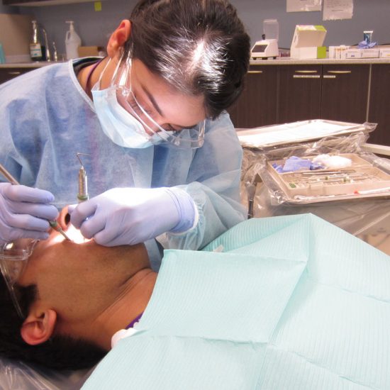 dentist student working with a patient