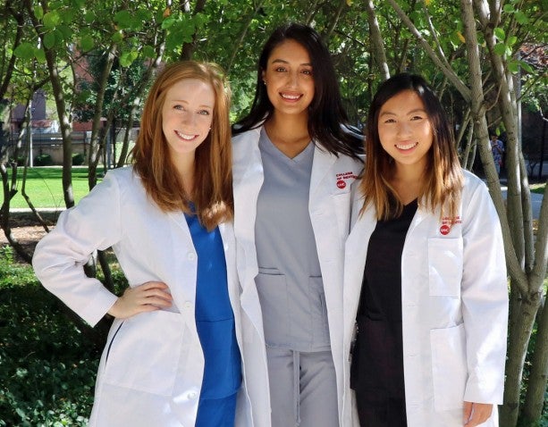 3 dentists smiling to camera