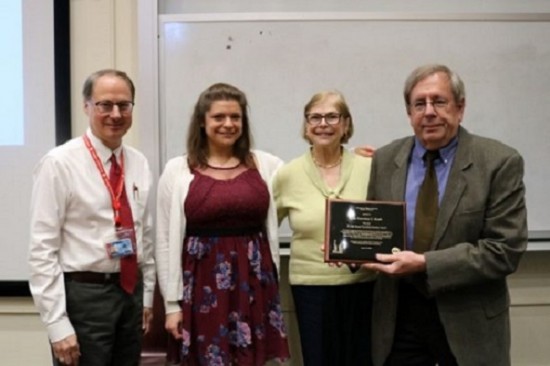 faculty group picture holding award