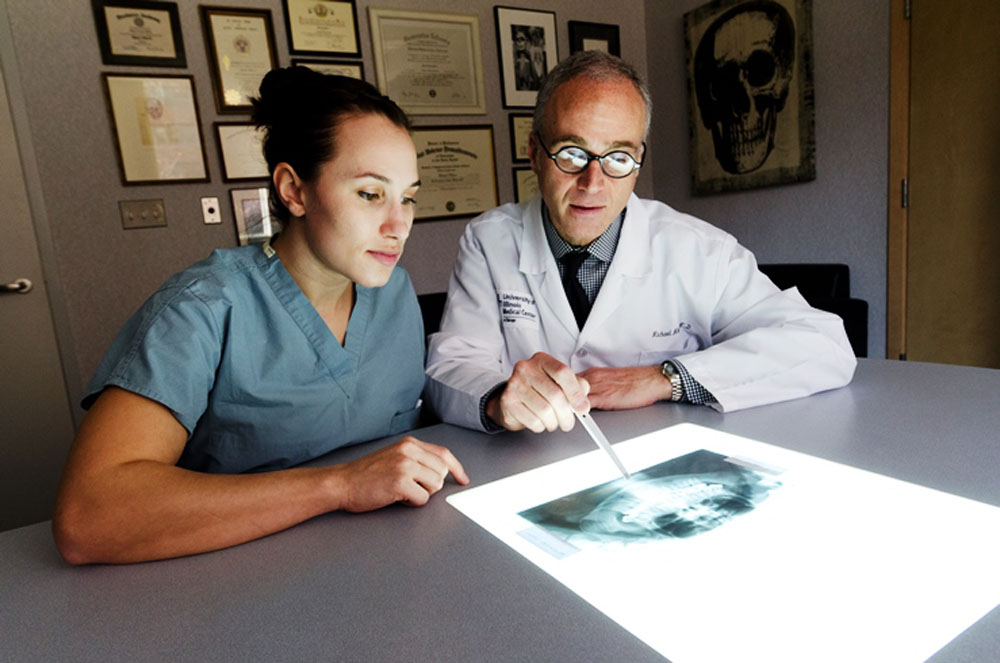 Two people reviewing an x-ray