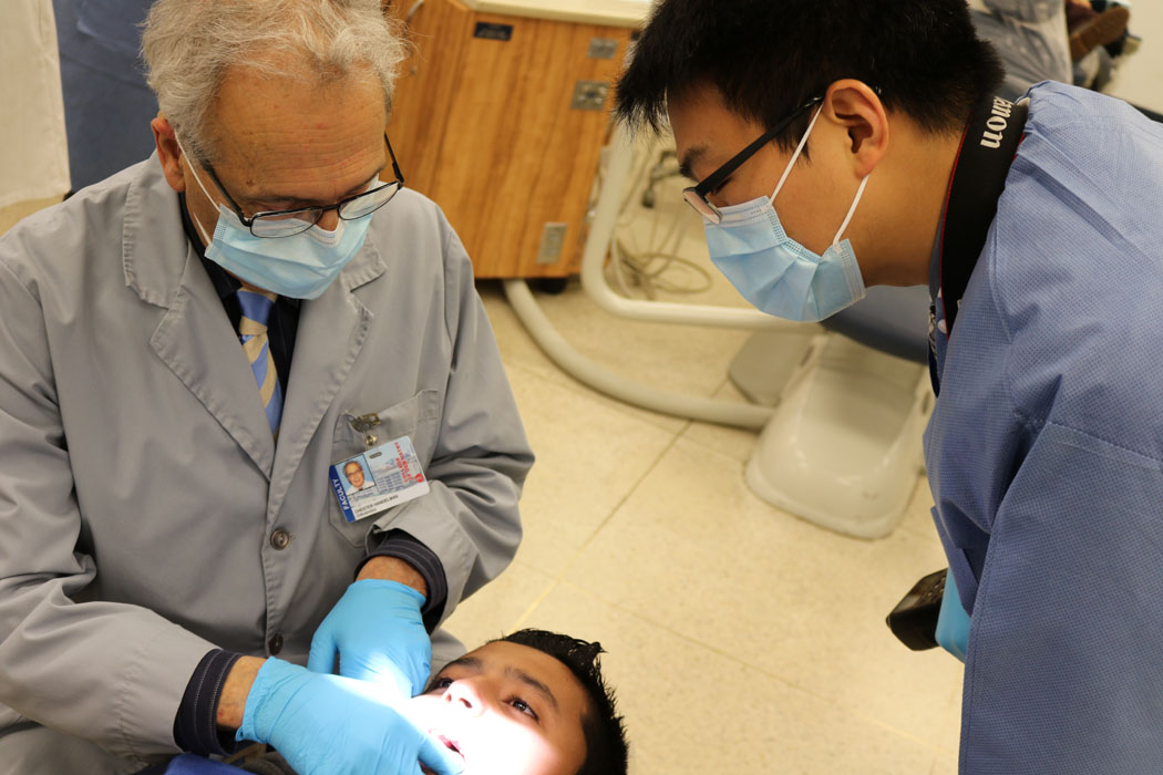 two dentists working on child