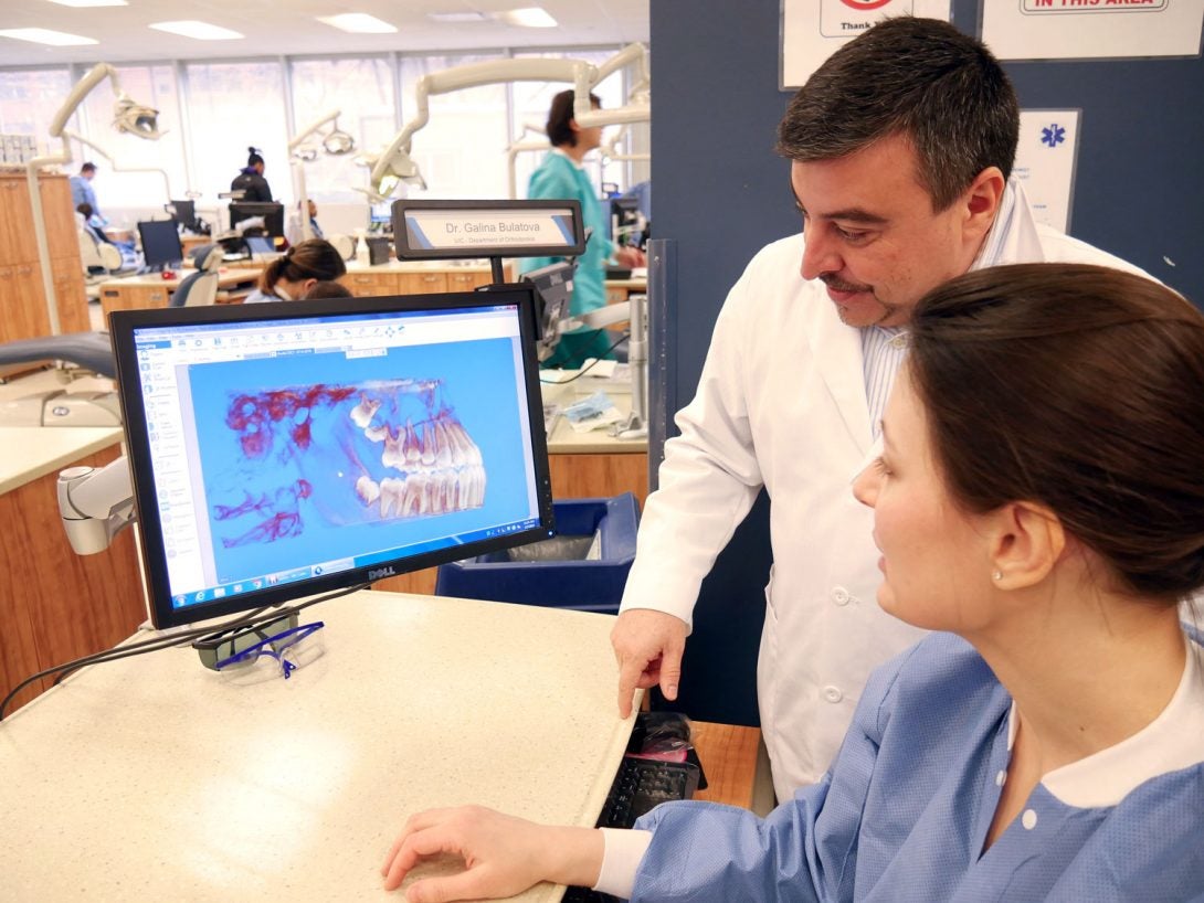 Orthodontic faculty and resident studying patient's 3D image