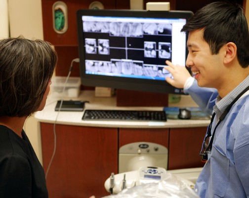 Dentist reviewing X-rays with patient