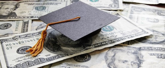 graduation cap on pile of money