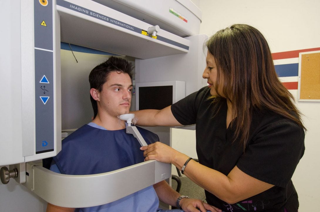 dentist scanning x-ray of patient's mouth