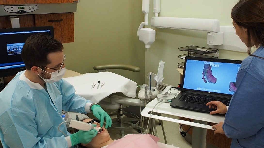 two dentists working on patient