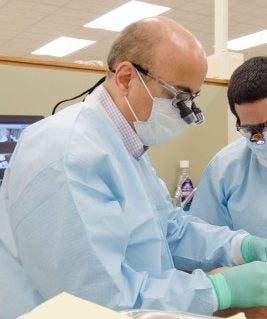 two dentists working on a patient