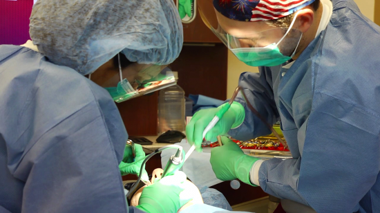 two dentists working on a patient