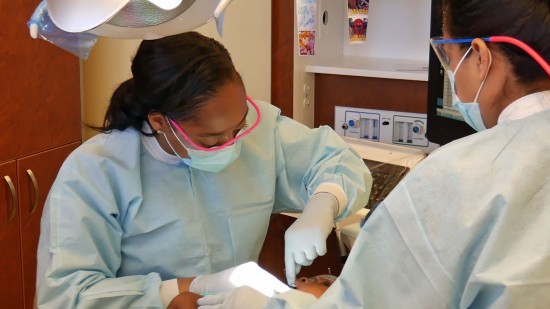 two dentists working on patient