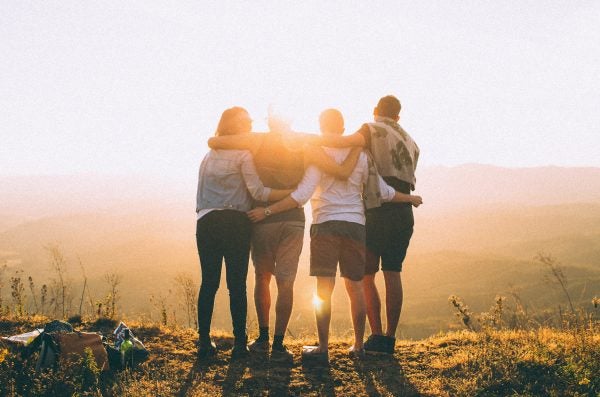 Group hugging at sunrise