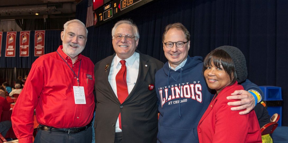 Dean Stanford and several colleagues wearing UIC gear