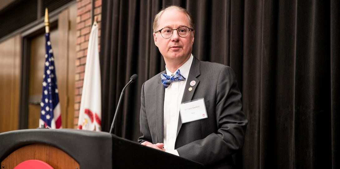 Dean Stanford at the podium at an event in 2018