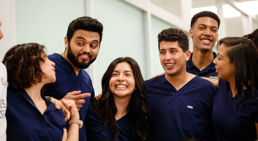 Diverse UIC Dentistry students in blue scrubs