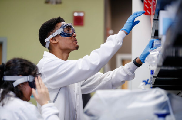 research students wearing goggles in the lab