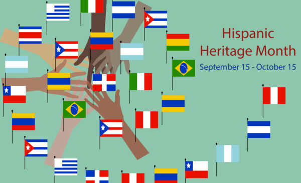 Hands holding various Hispanic flags