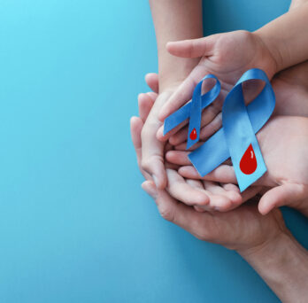 two hands holding diabetes prevention ribbons
                  