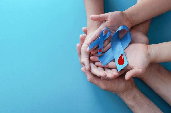 two hands holding diabetes prevention ribbons