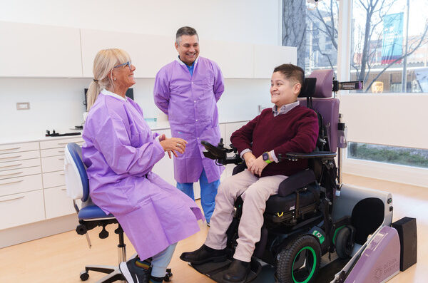 Patient in wheelchair receiving dental exam