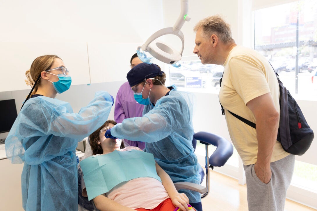 Waldemar Bladek looks on as his daughter Pauline receives treatment at the Inclusive Care Clinic.