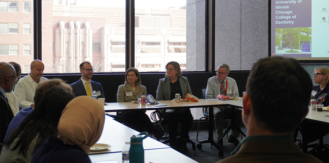 Group seated at tables in meeting room