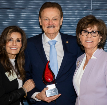Dr. George Zehak (center) with spouse Maria on left and Dean Susan Rowan on the right
                  