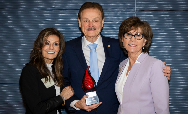 Dr. George Zehak (center) with spouse Maria on left and Dean Susan Rowan on the right