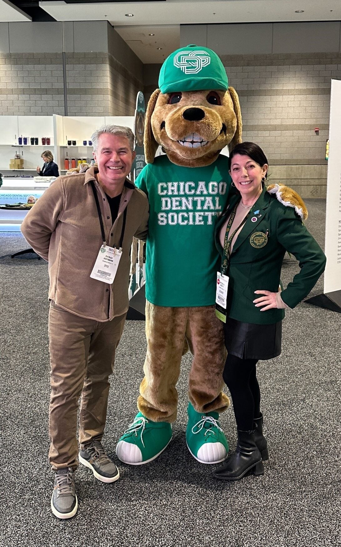 Man and woman pose with Chicago Dental Society mascot Hadley